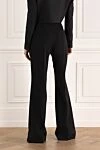 Женские шерстяные классические брюки клёш чёрные Balmain - расклешенный крой. два боковых кармана. шерсть. пуговица, молния. Страна производитель: Франция. Уход: специализированная чистка - фото 4